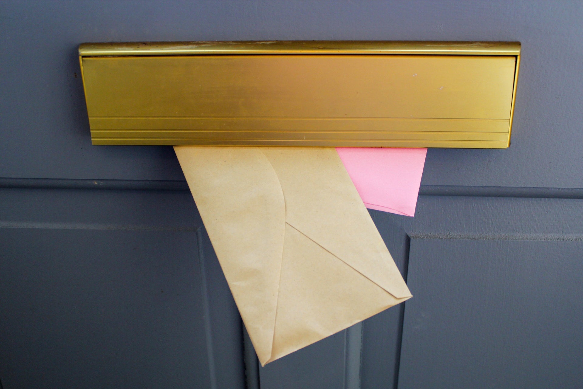 Envelopes being posted through a letterbox